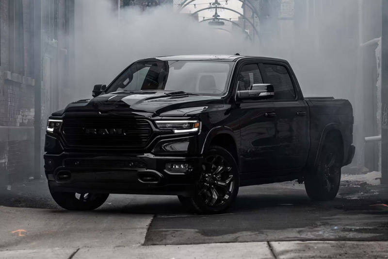 The 2023 Ram 1500 parked in a graffitied alleyway, surrounded by fog